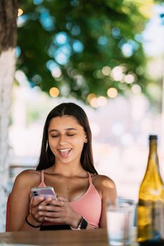 Photo of charming pretty young lady communicating modern gadget smiling outside urban city street
