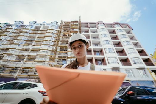 Woman construction engineer wear safety white hard hat at construction site. Woman construction Engineer concept