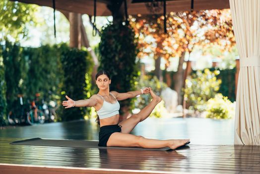 Young woman practicing yoga alone