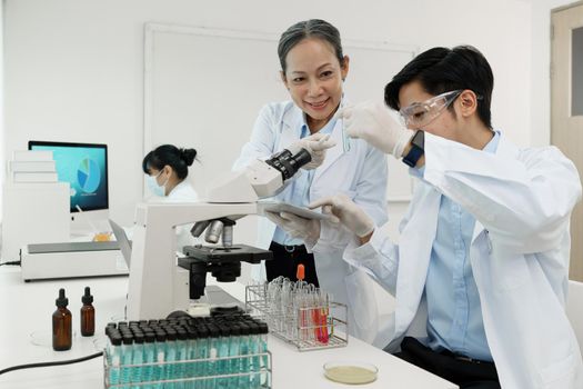 Scientist holding a test tube containing cannabis extract.