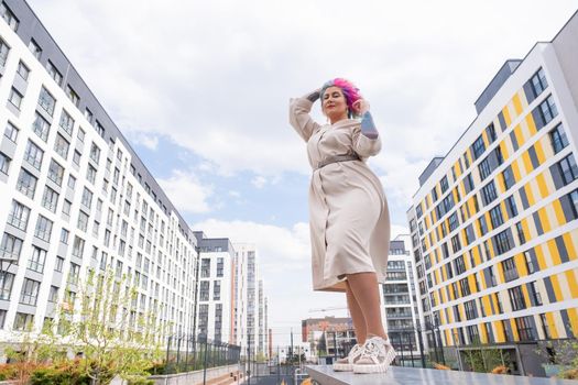 Portrait of a middle-aged woman with multi-colored hair walks on the streets of the city