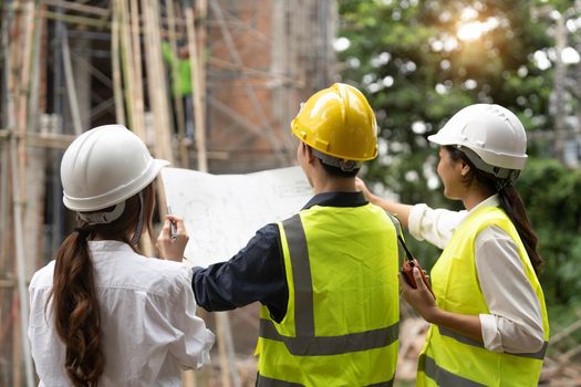 Engineer and Architect working at Construction Site with blue print, Construction concept