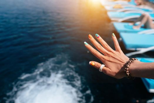 Women beautiful manicure in the pool.