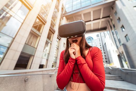 A woman in a virtual reality helmet walks down the street