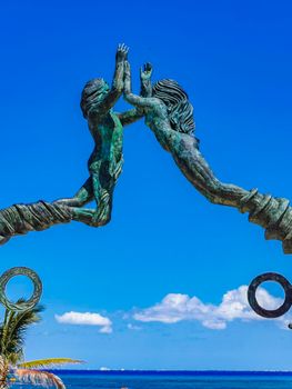 The ancient architecture of the Portal Maya in the Fundadores park with blue sky and turquoise seascape and beach panorama in Playa del Carmen Quintana Roo Mexico.