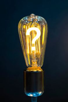 Bulb with glowing question mark inside of it, creativity concept