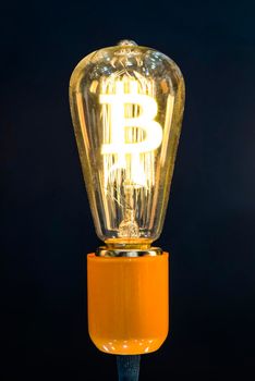 Money making idea. Light bulb with Bitcoin symbol.