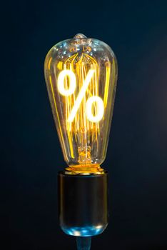 Bulb with glowing percent mark inside of it, creativity concept