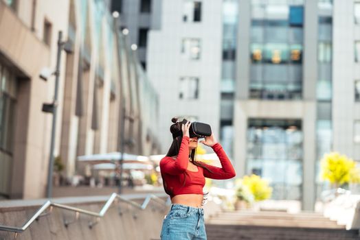 A woman in a virtual reality helmet walks down the street