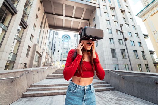 A woman in a virtual reality helmet walks down the street