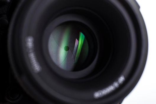 Camera lens close-up on white background