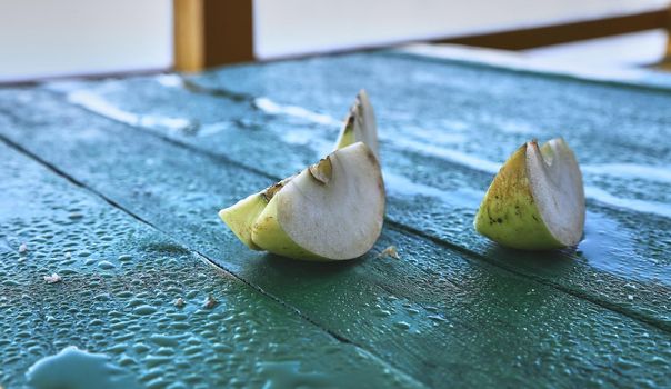 Green apple slices. Apples on a green table. Half, green apple slice.