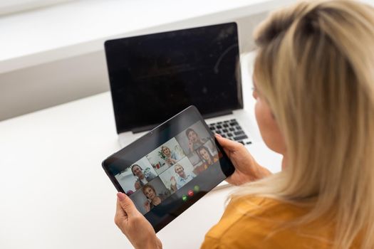 Smiling millennial woman using modern gadget, chat on tablet device, technology concept.