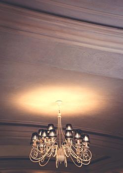 chandelier shines on the ceiling