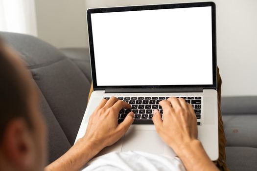 Cropped image of a young man working on his laptop, rear view of business man hands busy using laptop, typing on computer.