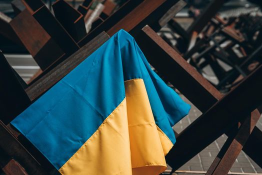 The Ukrainian flag hangs on barricades on the street