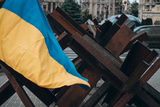 The Ukrainian flag hangs on barricades on the street