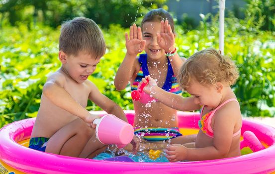 Children swim in the pool. Selective focus. Kid.