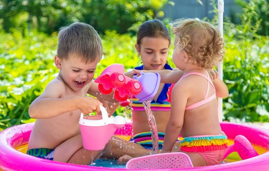 Children swim in the pool. Selective focus. Kid.