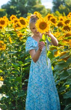 Woman in a field of sunflowers. Ukraine. Selective focus. Nature.