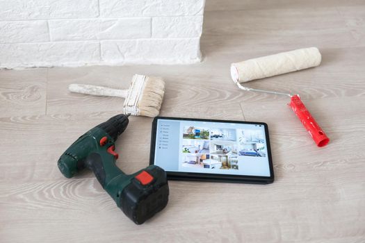 A tablet with a white blank display next to a construction tools