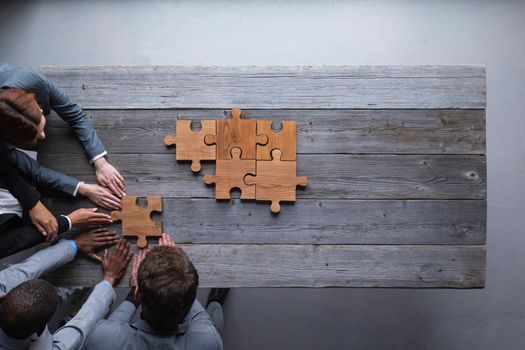 Business people team work with wooden puzzle cooperation unity concept, copy space for text