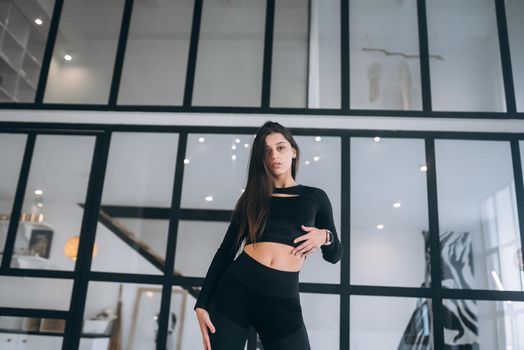 Photo of adorable pretty young girl dressed sport suit practicing aerobics smiling indoors house home