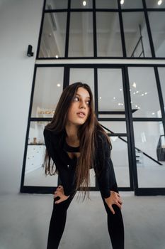 View of flexible girl exercising yoga pose indoors.