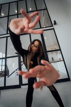 View of flexible girl exercising yoga pose indoors.