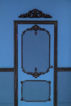 Old dramatic blue doors on the background of the wall.