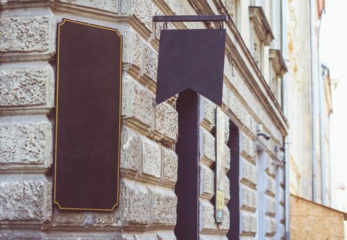 An old retro signboard on the wall of the old city.