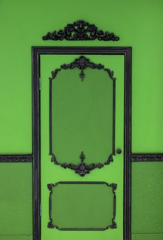 Old dramatic green doors on the background of the wall.