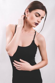 Portrait of nice young gorgeous woman on gray solid backgrounds.