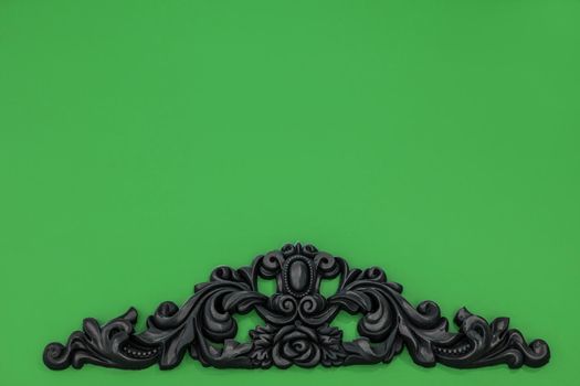 Vintage royal silver horizontal background with black ornaments on a green wall