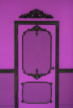 Old dramatic pink doors on the background of the wall.