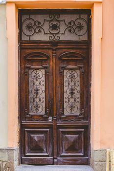 The old wooden door in the old courtyard of the city.