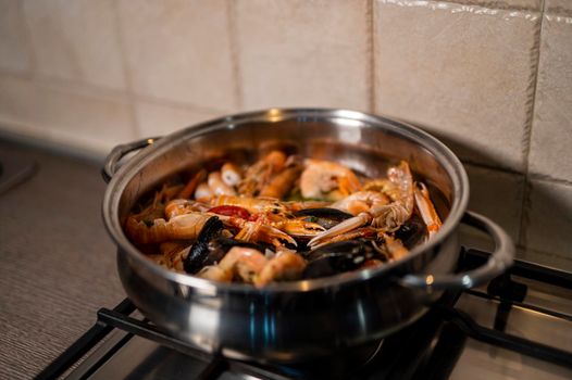 fish soup in gravy in the pot while cooking