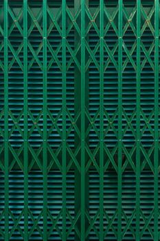 Closed shutters and grating textured green background