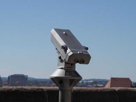 binocular at viewing platform in elevated place over the city centre