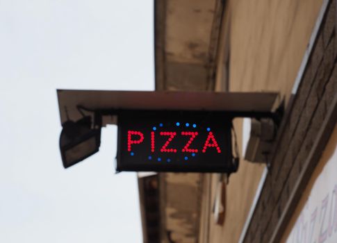 LED pizza sign at take away pizza restaurant