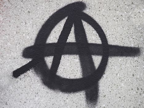 Anarchy symbol spray painted on a wall