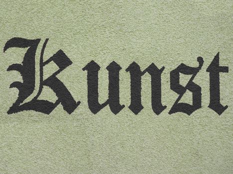 kunst translation art written in gothic characters font on a wall