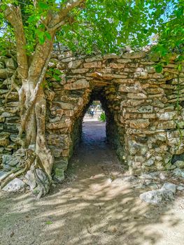 Ancient Tulum ruins Mayan site with temple ruins pyramids and artifacts in the tropical natural jungle forest palm and seascape panorama view in Tulum Mexico.