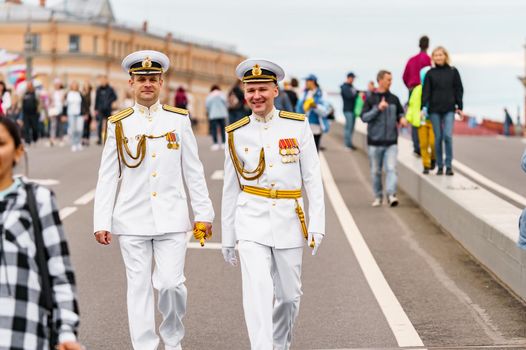 Russia, St. Petersburg, 31 July 2022: A lot of people at celebration of day of Navy on Blagoveshensky bridge, military sailor dressed in festive uniform. High quality photo