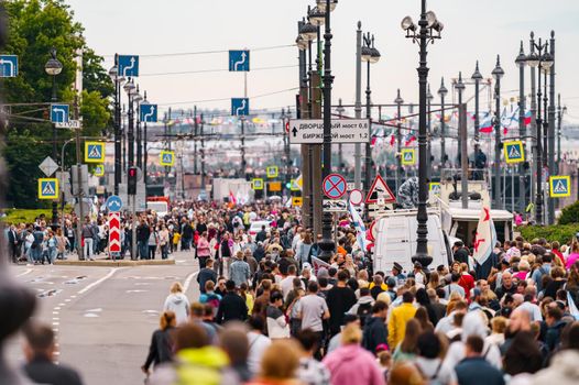 Russia, St. Petersburg, 31 July 2022: A lot of people during celebration of day of Navy on university embankment, lampposts . High quality photo