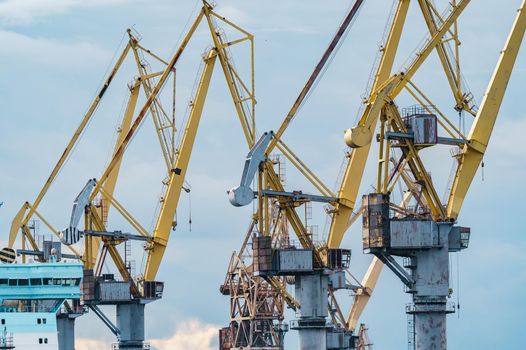 construction cranes of the shipyard on the Neva River in St. Petersburg in cloudy weather. High quality photo