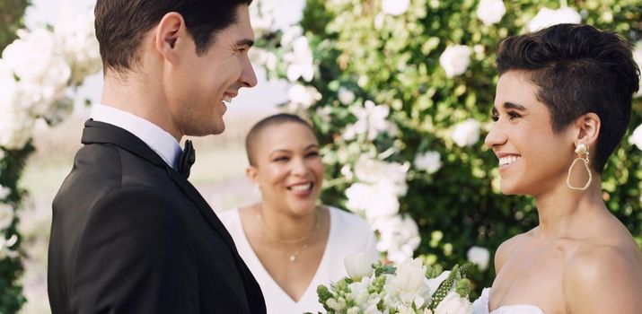 Im standing here as the luckiest man on earth. an affectionate young couple smiling at each other while saying their vows on their wedding day