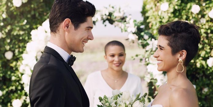 Loving you makes life worth living. an affectionate young couple smiling at each other while saying their vows on their wedding day