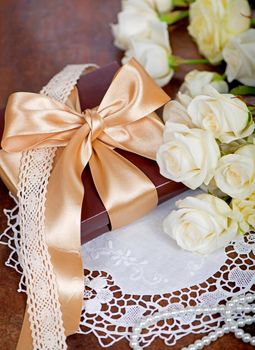 bouquet of white rose with green leaves on a wooden