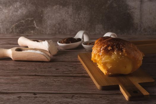 cream-filled puff pastry horn on a wooden board
